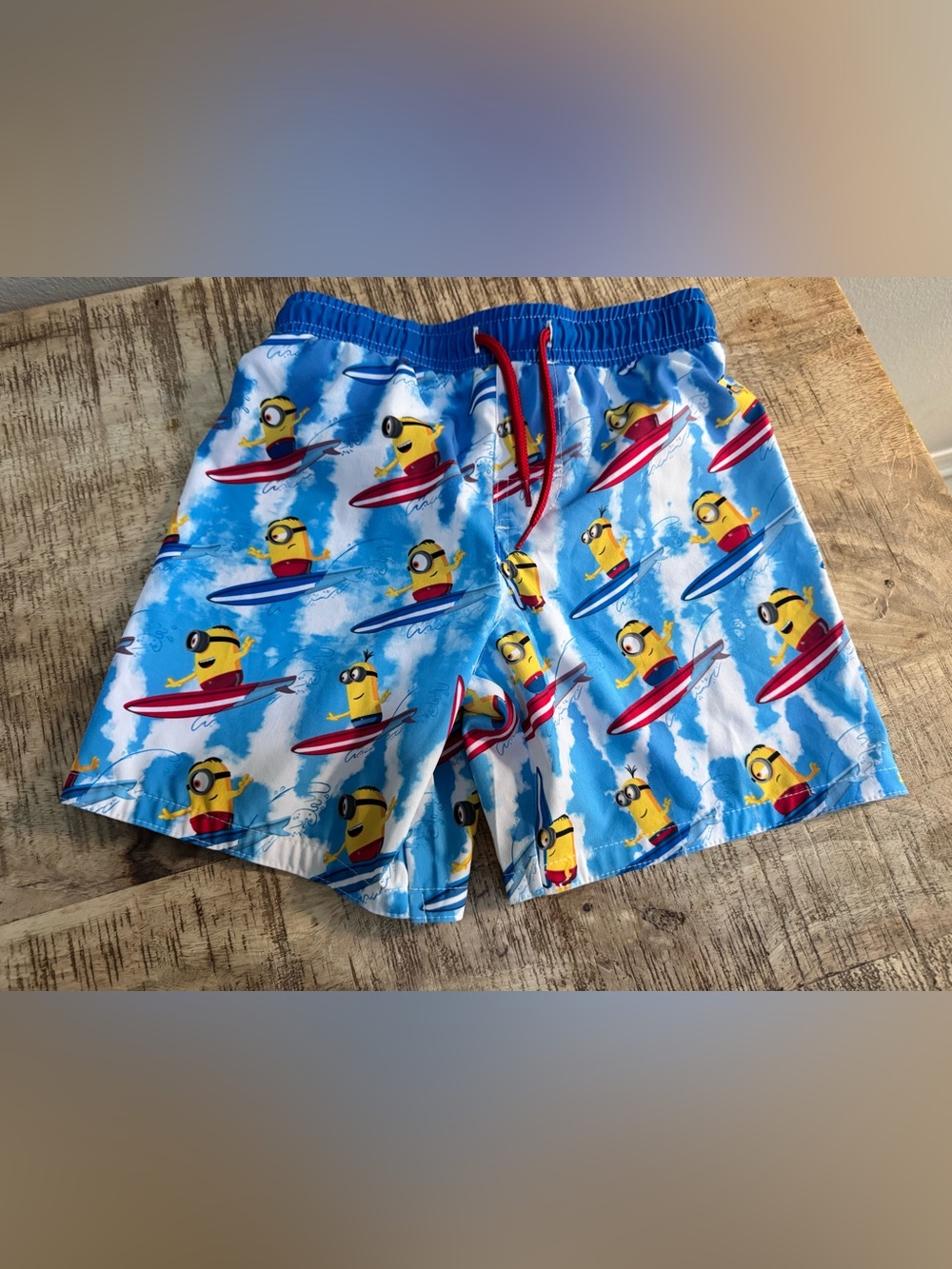 Boys Blue Minions Surf Print Swim Shorts with Red Drawstring